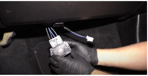 mechanic wearing gloves holding the wiring