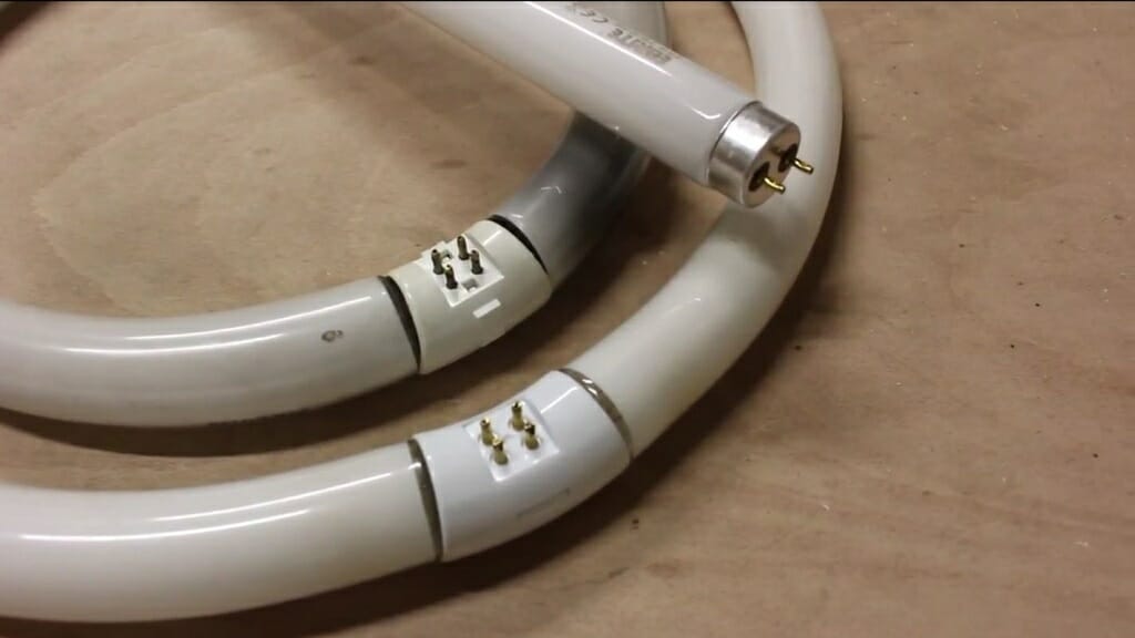 Two circular and one fluorescent on top of each other in the table