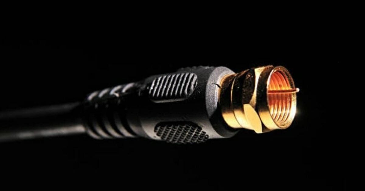 A close up image of a coaxial cable in a black background