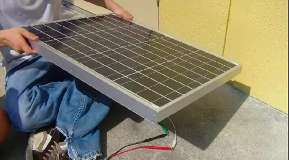man holding a solar panel