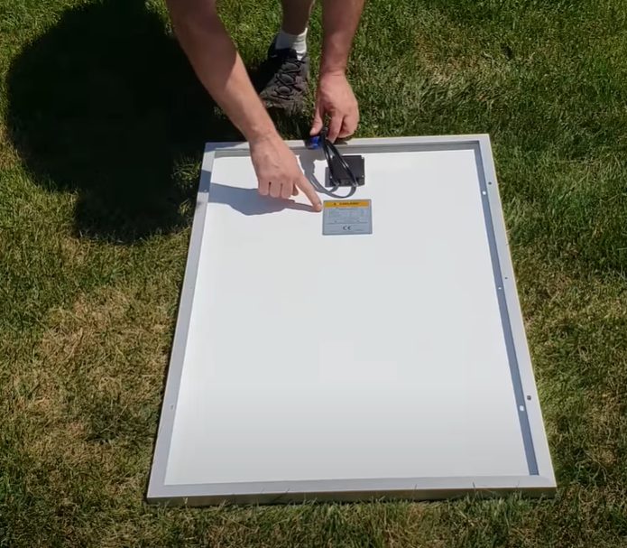 man setting up solar panel