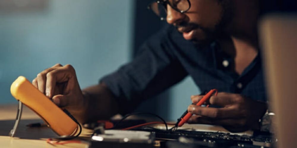 technician checking his multimeter settings