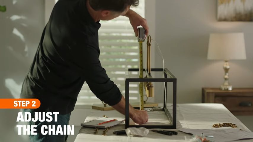 adjusting the chain of the light fixture chandelier