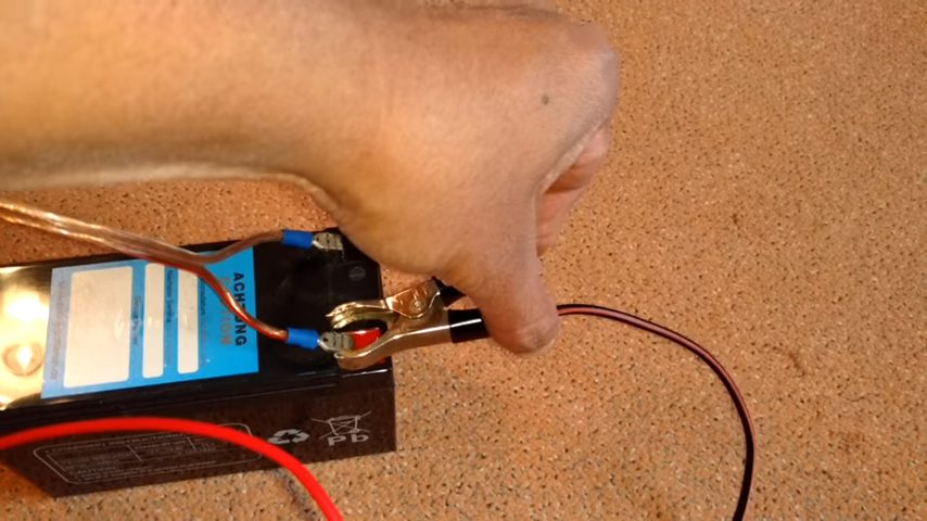 attaching spark plug to positive terminal of the battery