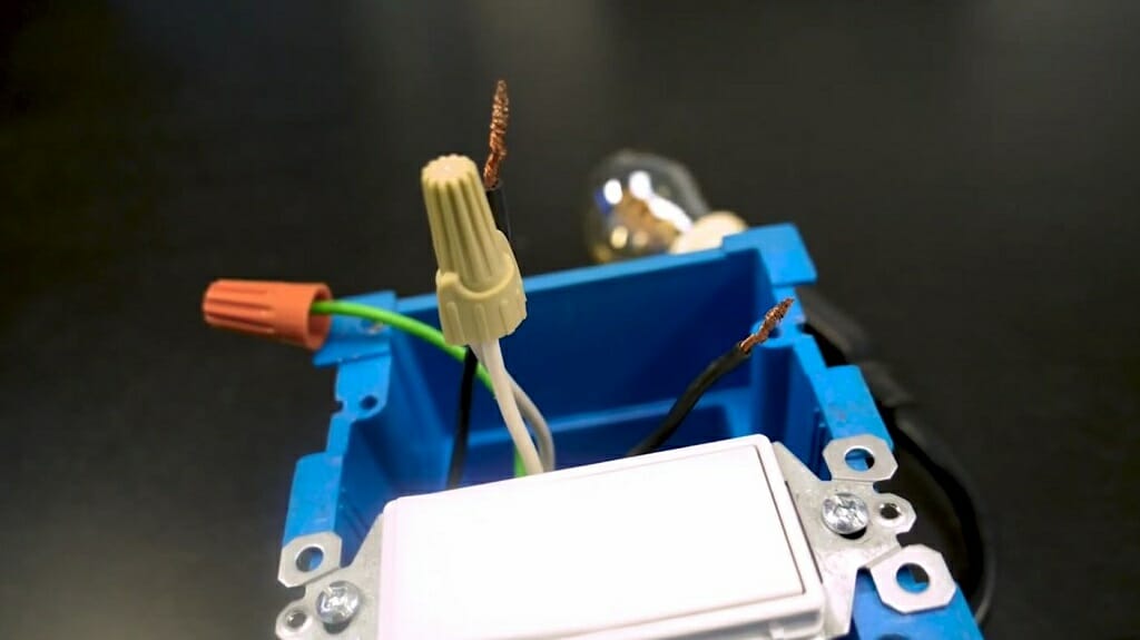 capped wires in a blue electrical box