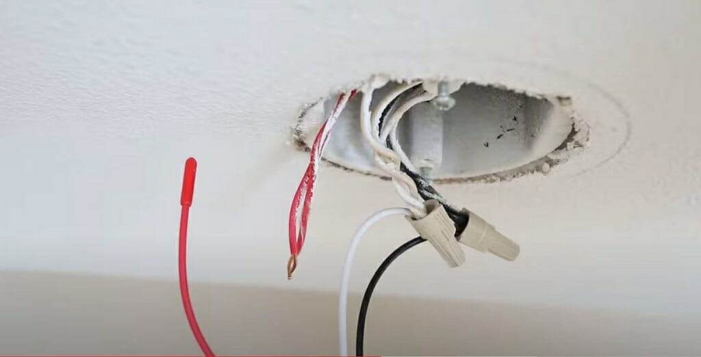 connecting the harness's red wire to the NM cable's red wire