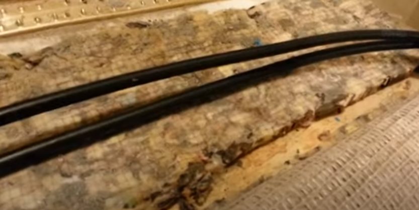 cut the foam underneath the rug and place the wire in between the foam