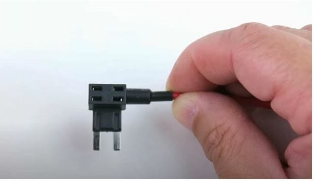 hand holding fuse tap