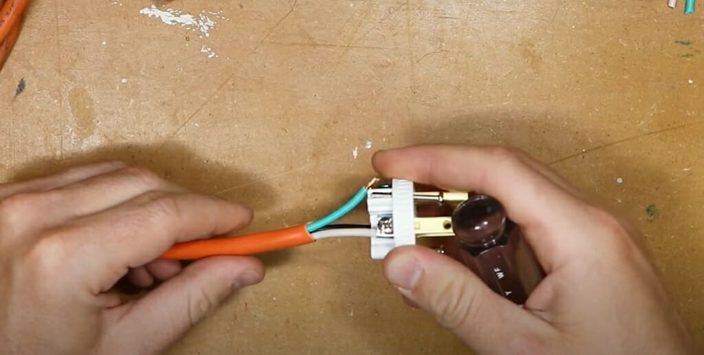 inserting the stripped wire into the male plug