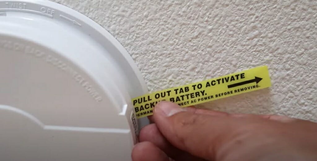 pulling out the plastic tab to activate the backup battery
