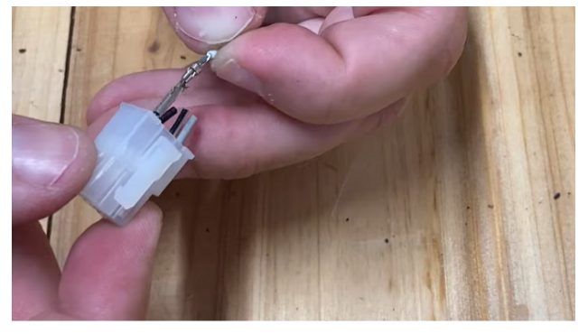 pushing the extraction tool into the hole with little pressure