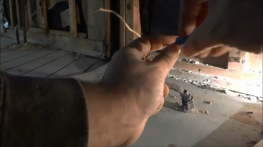 A man putting the wire nuts on the wires