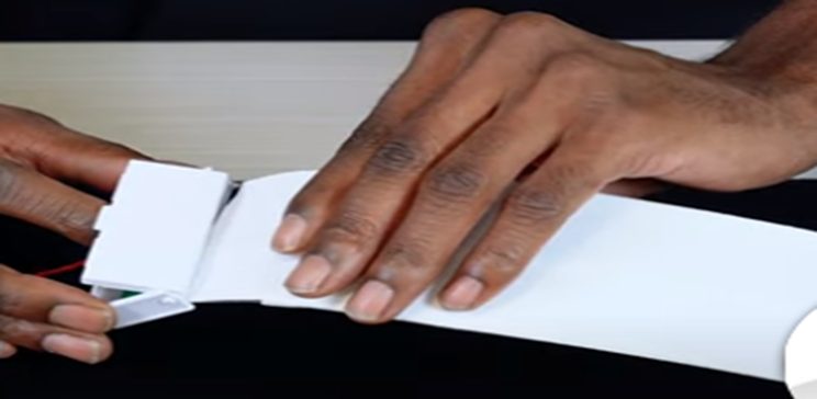 sliding the flat cable into the connector