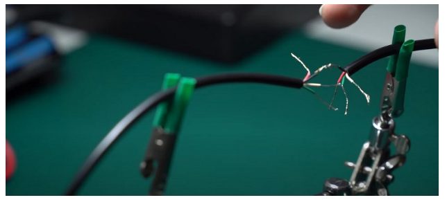 A person cutting the usb cable