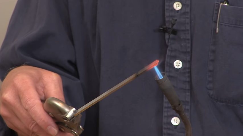 A person heating a rod