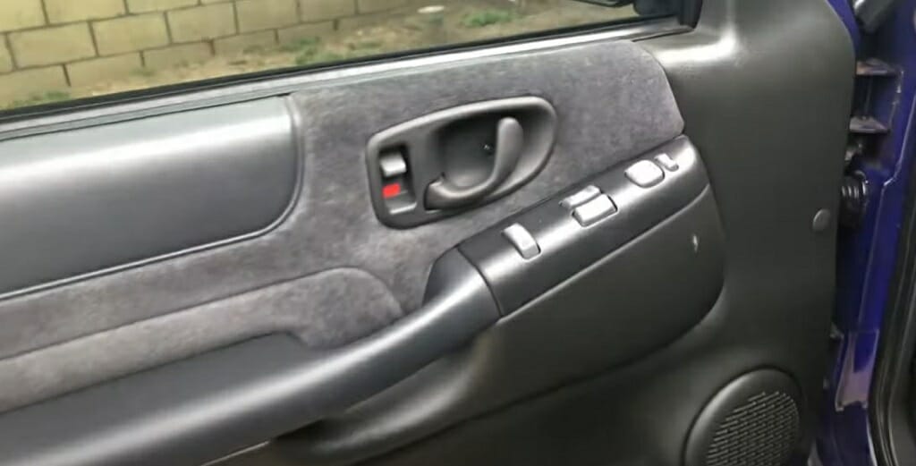 A reassembled door panel with speaker inside it