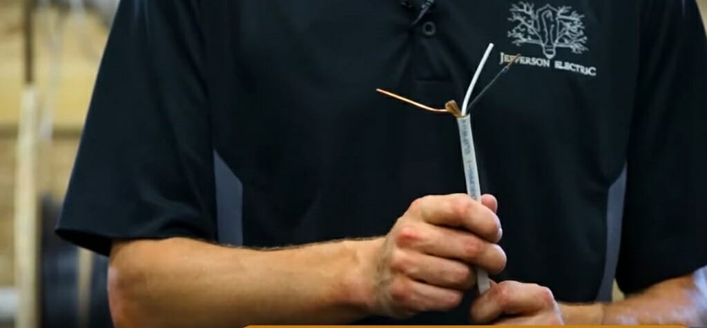 man holding gauge wire