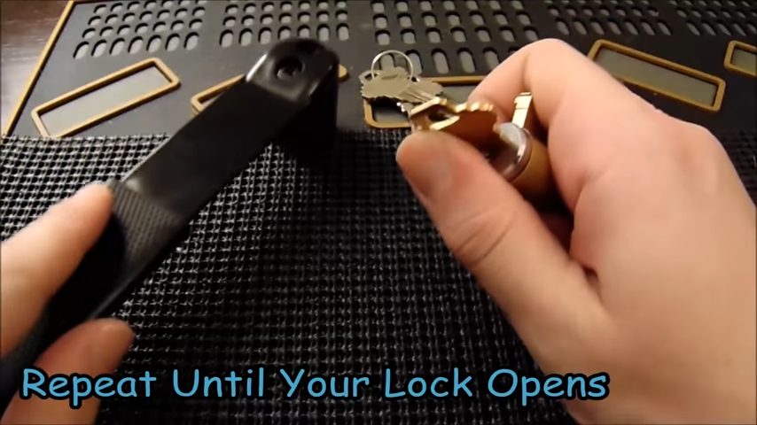 A person is holding a non-regular hammer, a lock with a key