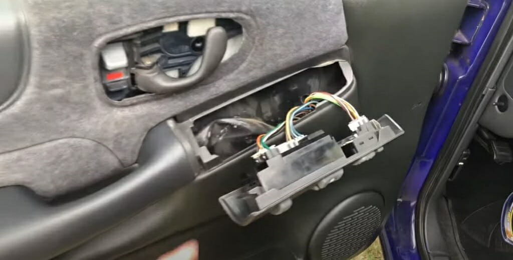 A person is removing car door's panel