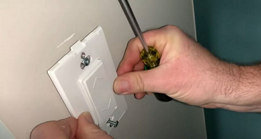 screwing back the switch cover