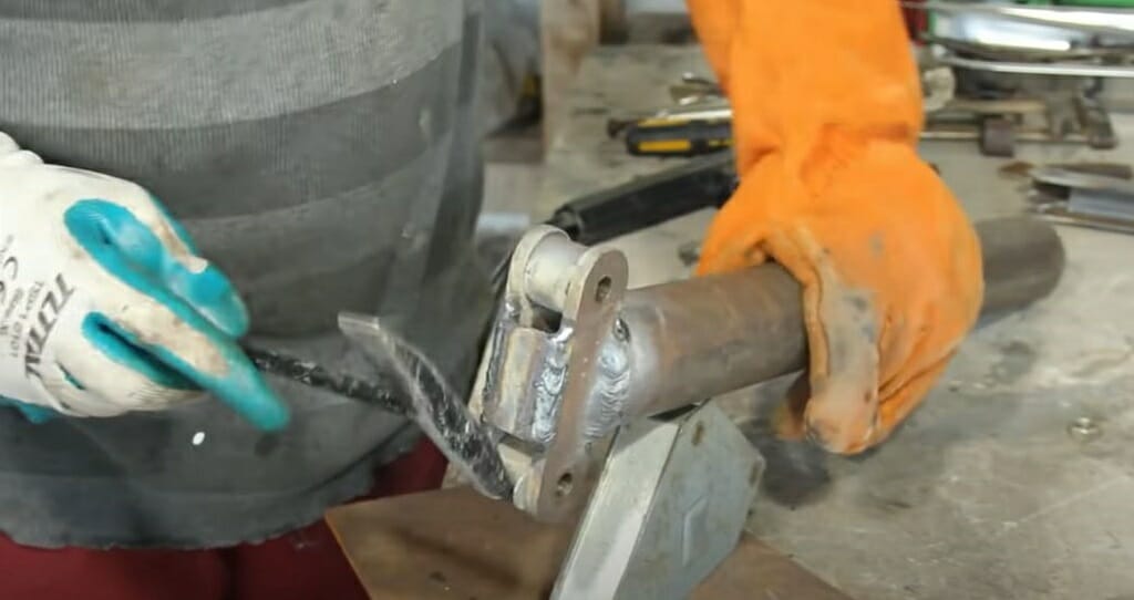 connect support piece to 2-inch-thick steel rod