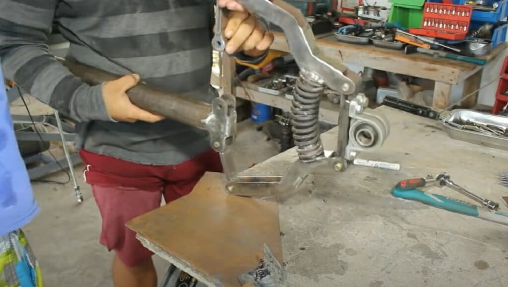 connecting the 2-inch steel rod to the shock spring