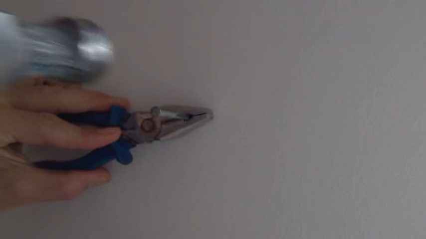 grab the nail with a pair of pliers