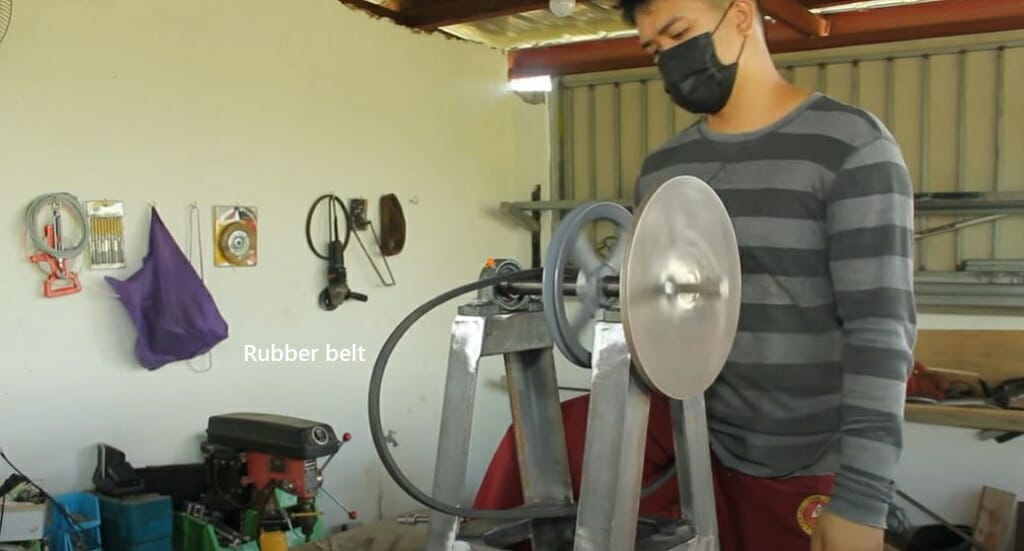 placing the rubber belt on the pulley assembly