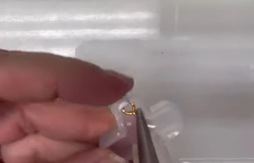 pushing eyelet screw through the hole