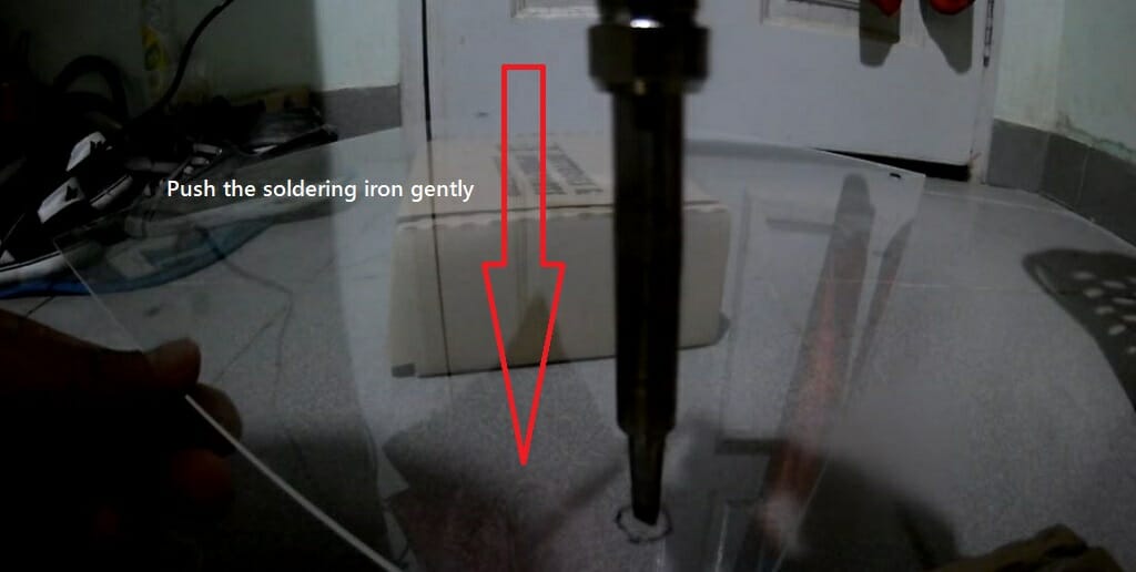 pushing the soldering iron