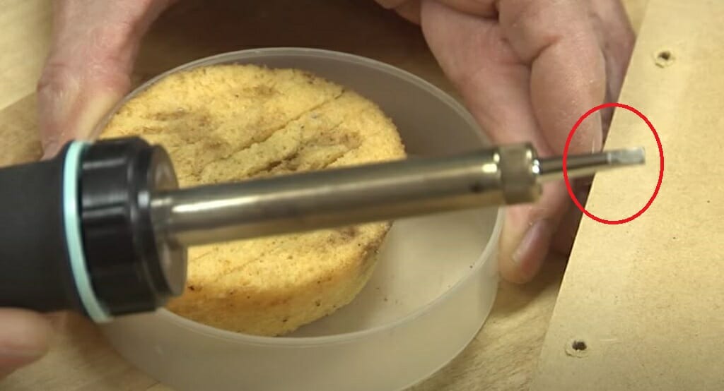 using wet sponge to clean solder