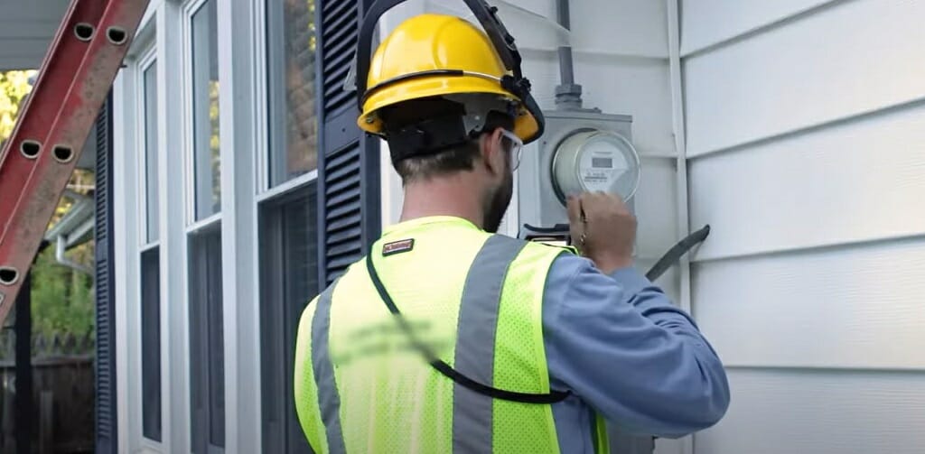 a professional electrician checking the electric meter