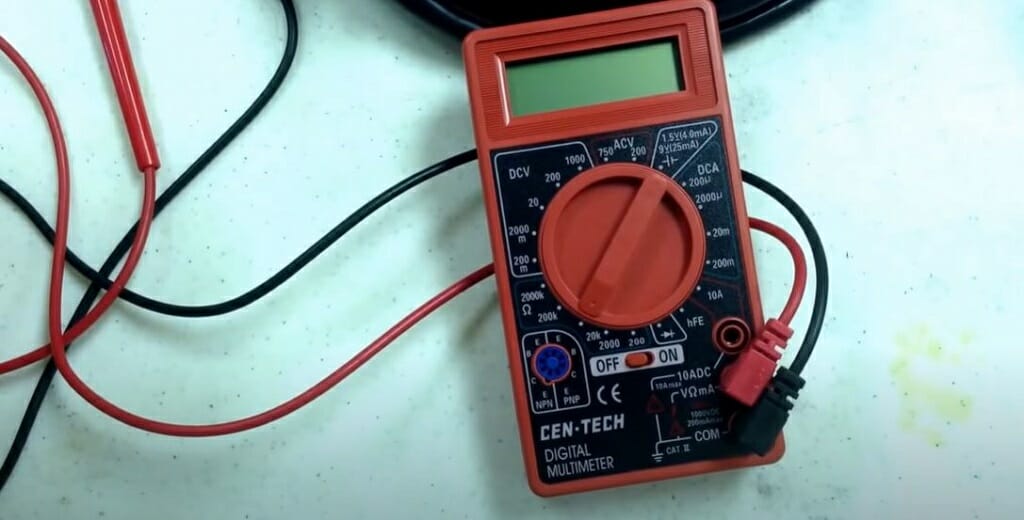 CenTech multimeter with probes attached to its jack