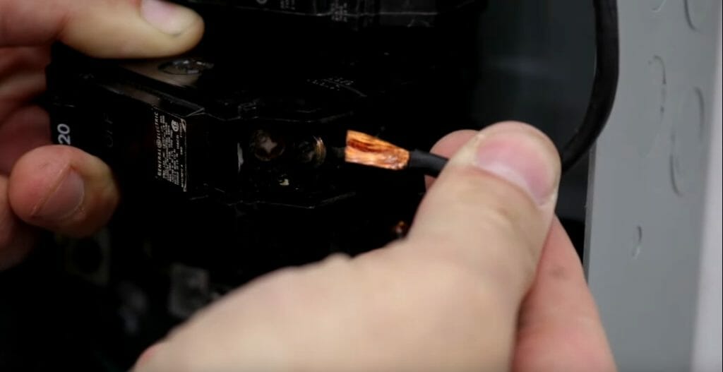 a person pulling the wire out