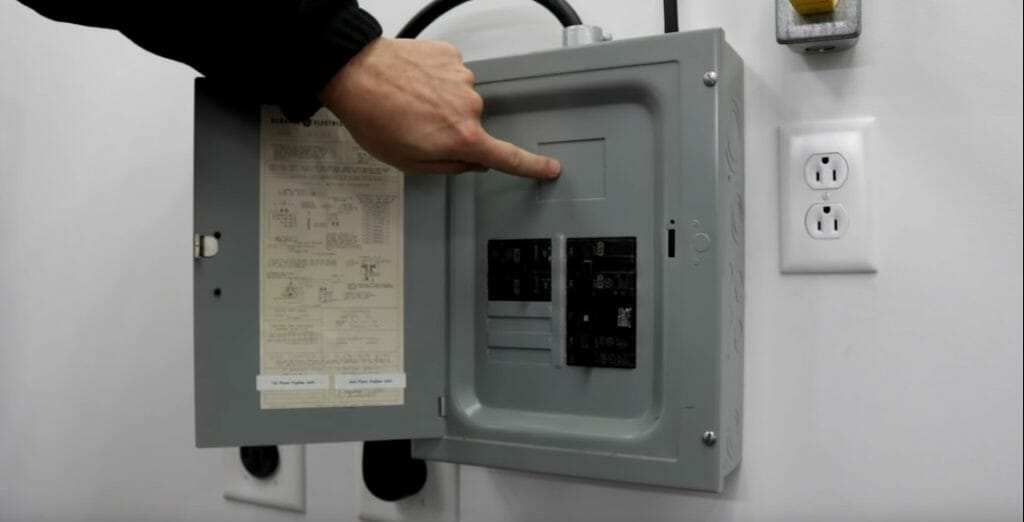 a person turning the main breaker off