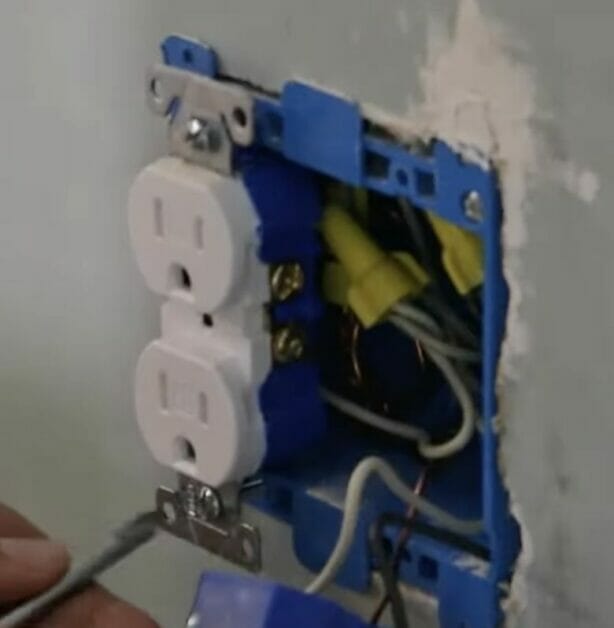 A person removing the outlet