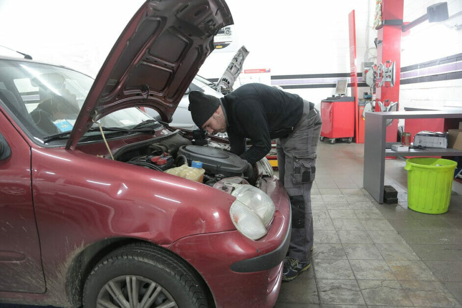 man checking the car hood