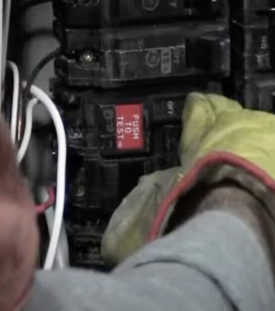 pushing the breaker in a panel