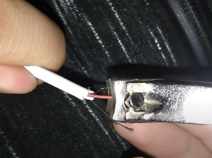 stripping the red and black wires using nail cutter
