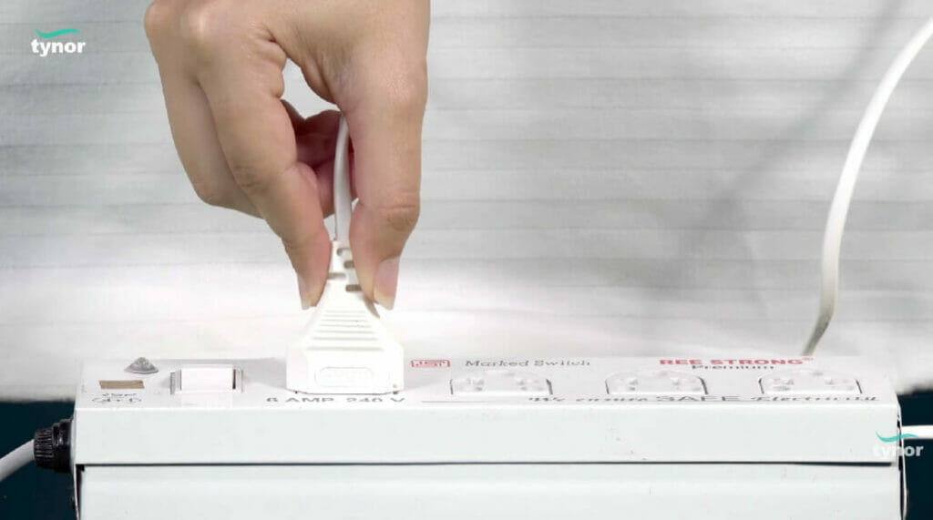 a hand plugging in a wire on the extension cord