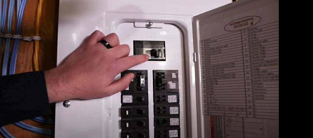 A man checking the main electric panel