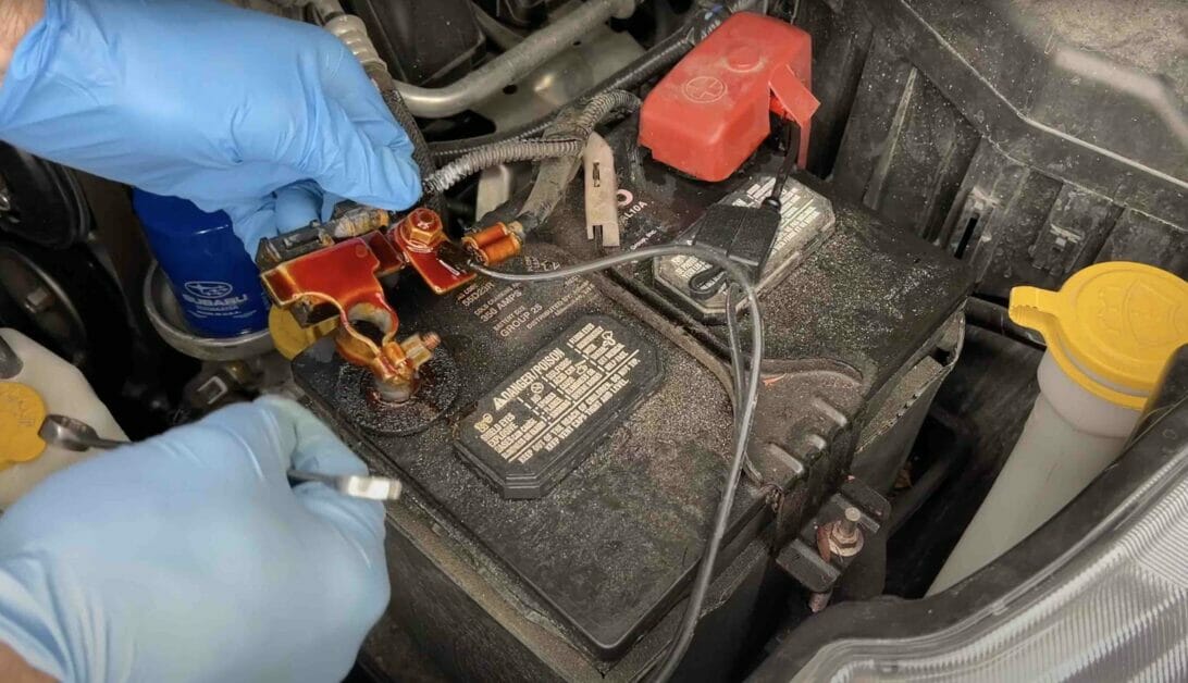 man wearing a blue gloves performing a group 24 battery upgrade