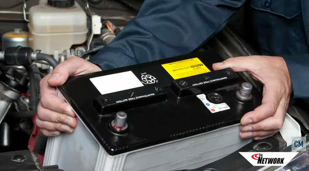 mechanic installing an AGM battery to a car