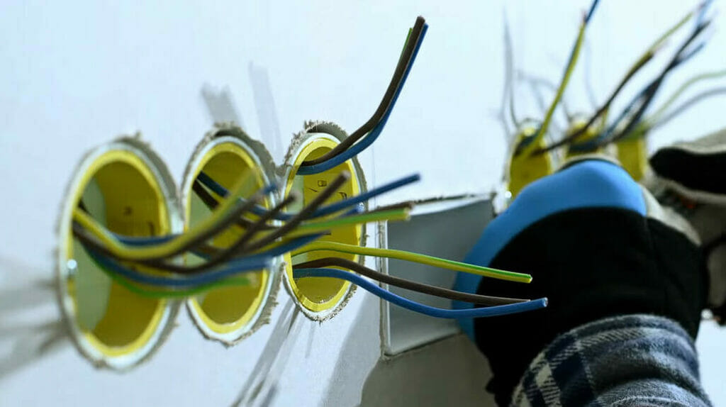 an undone outlet and switches wires