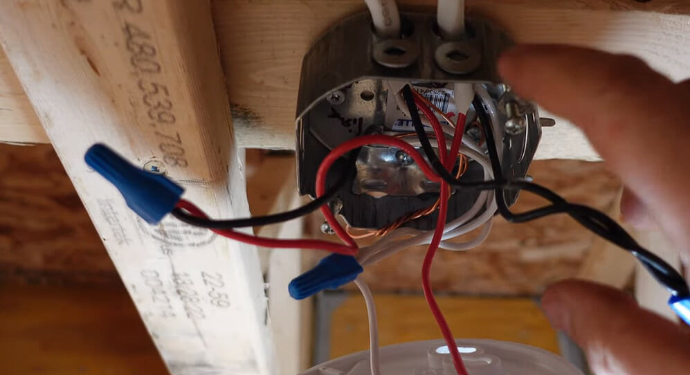 electrician checking on wires on an electrical box