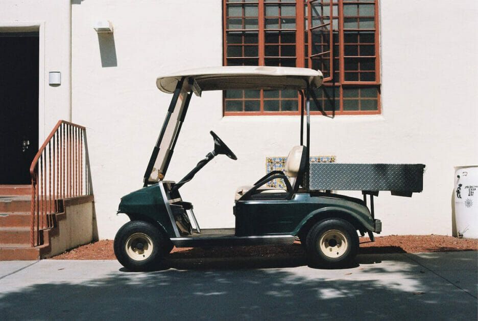 golf cart parked at the side of the building