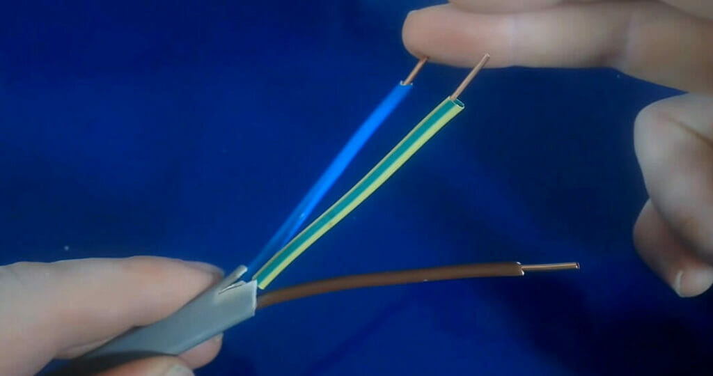 hands holding a stripped wires