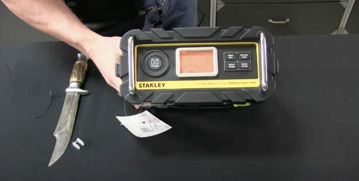 man unboxing STANLEY 15amp battery charger