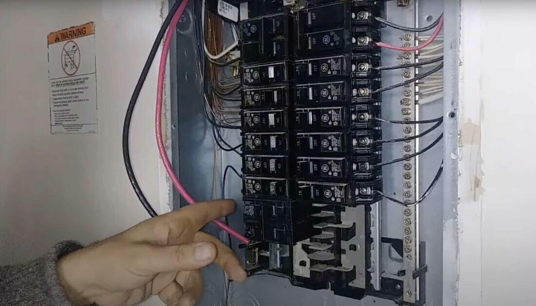 man working on the wirings of a circuit breaker