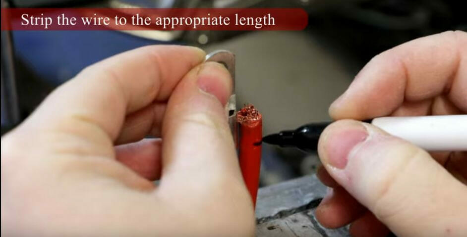 A person cutting and marking the wire to the required length